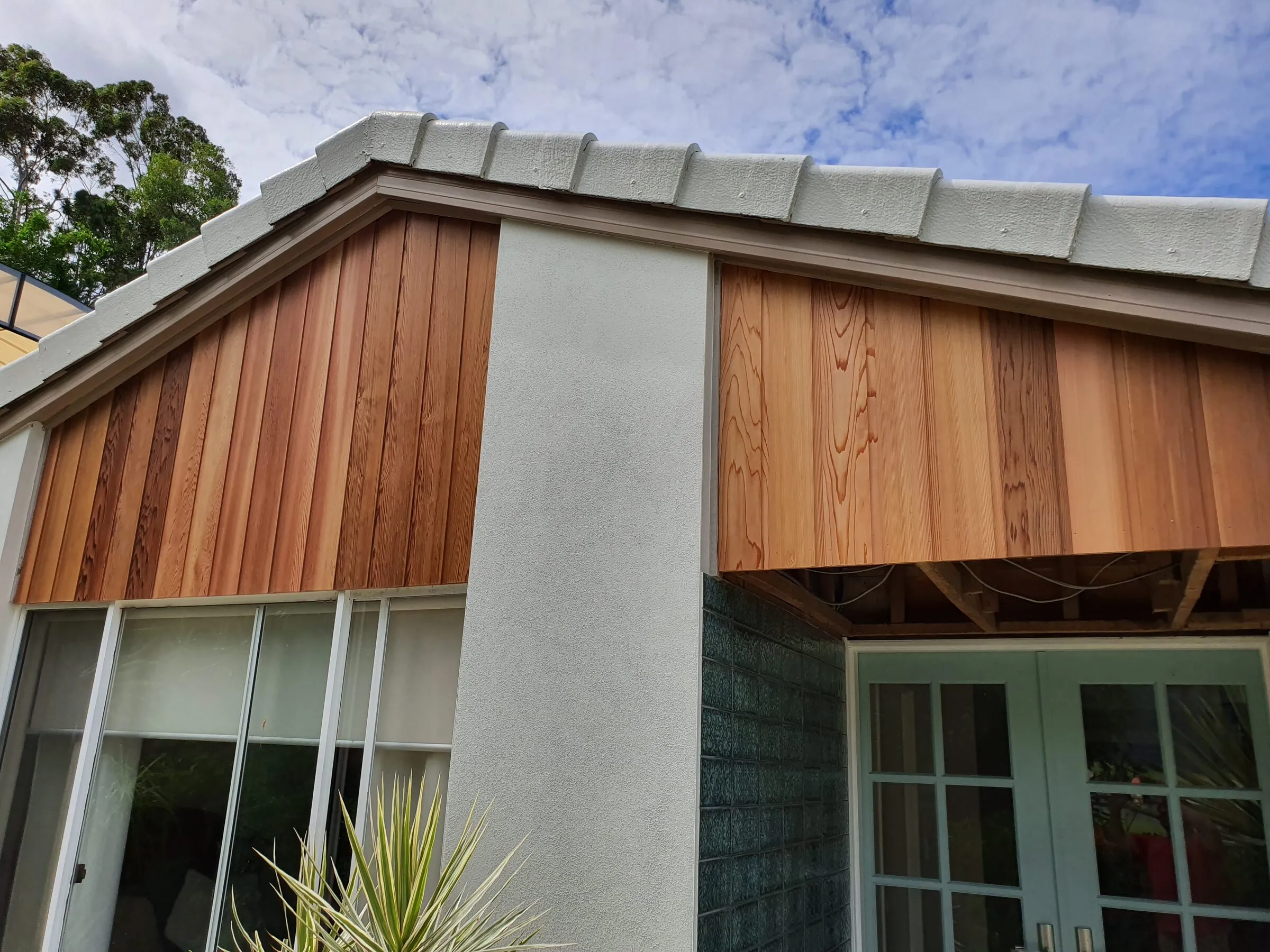 New cedar boards on the gable end, run down to the window head and left to weather.