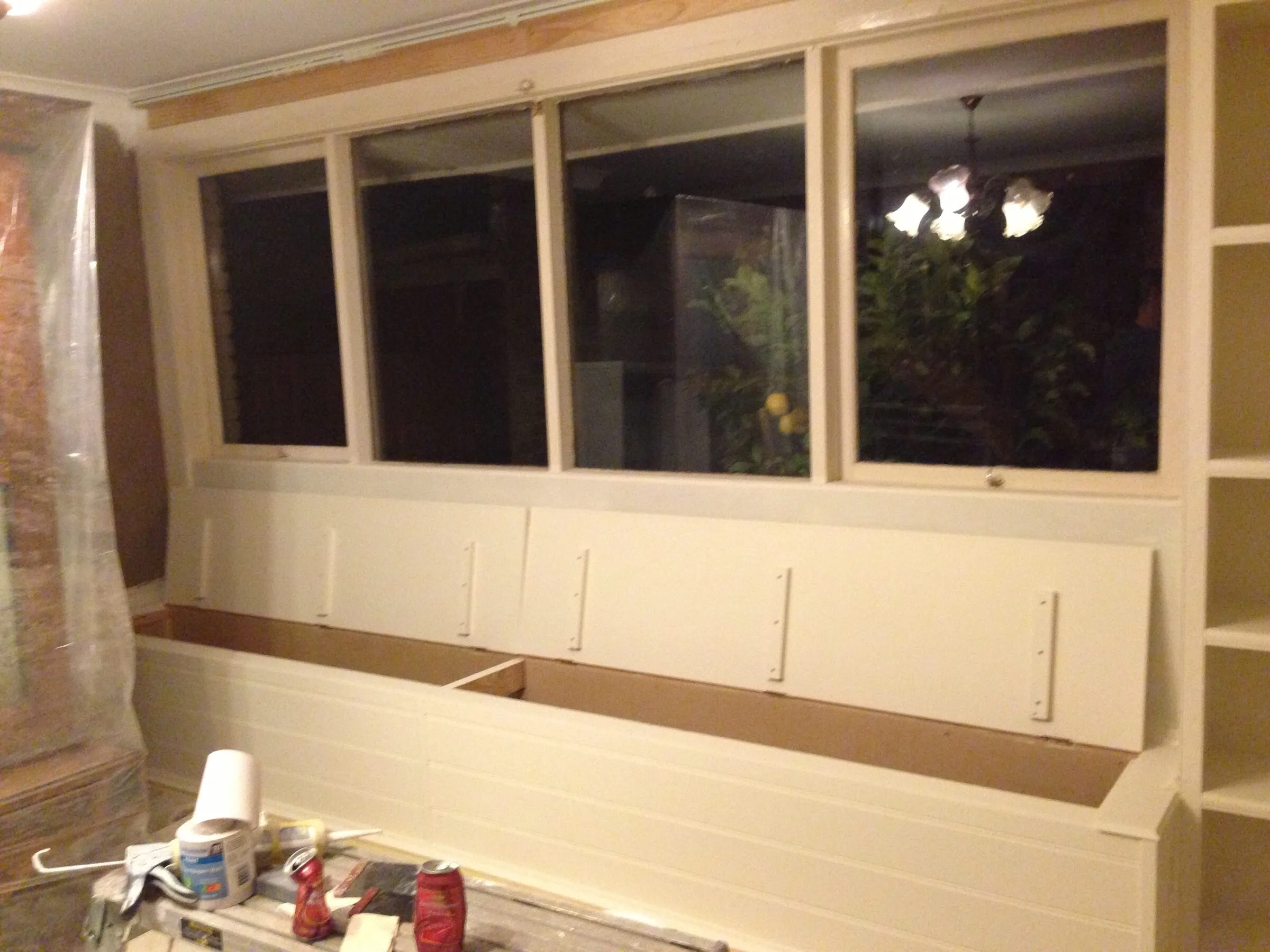 A window seat with storage under, primed and fitted beneath the front windows.